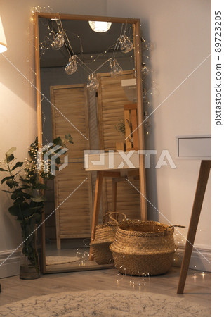Large mirror near light wall in room. Modern interior design Large mirror near light wall in room. Modern interior design 89723205