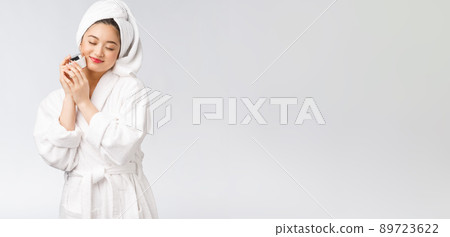 Beauty concept. Asian pretty woman with perfect skin holding cosmetic bottle. Beauty concept. Asian pretty woman with perfect skin holding cosmetic bottle. 89723622