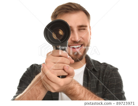 Young man with vintage video camera on white background, focus on lens Young man with vintage video camera on white background, focus on lens 89723971
