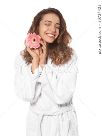 Beautiful young woman with flower wearing bathrobe on white background Beautiful young woman with flower wearing bathrobe on white background 89724422