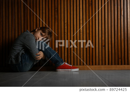 Abused little girl showing with phrase HELP ME near blue wall, focus on hand.  89724425