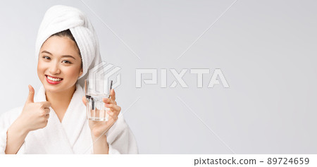 Healthy young beautiful woman drinking water, beauty face natural makeup, isolated over white background. 89724659