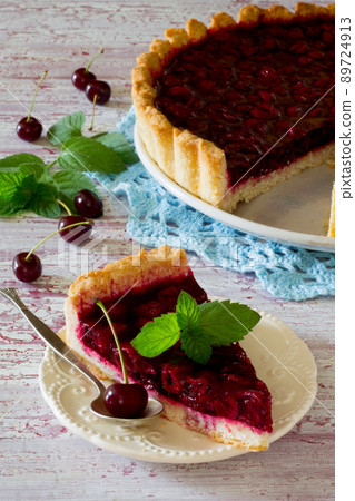 Homemade cherry pie, shortbread dough and cherry jelly on top 89724913