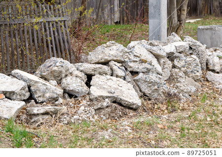 Pile of stones on the ground construction, a destructive pile, a destroyed road, and then dumped on the ground Pile of stones on the ground construction, a destructive pile, a destroyed road, and then dumped on the ground 89725051