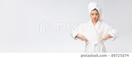 Young beautiful woman wearing shower towel after bath over isolated white background pointing with finger. Young beautiful woman wearing shower towel after bath over isolated white background pointing with finger. 89725874