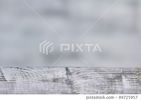 Thick glass mirror on gray wooden desk. 89725957