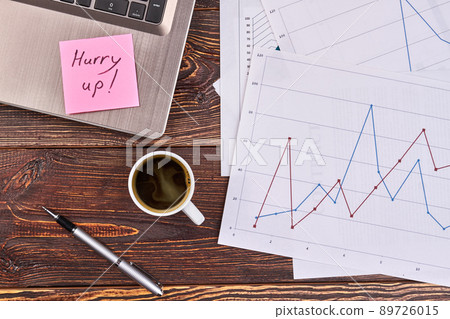 Papers with statistic with cup of strong coffee. 89726015