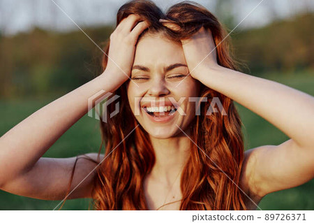 Woman smiling beautiful with red hair close-up portrait looking at camera 89726371