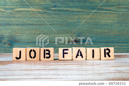 Job Fair. Text from alphabet blocks on a green and white wooden background 89726531