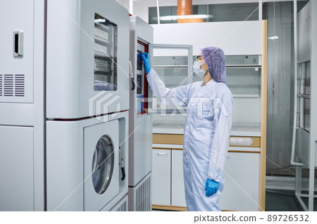 A female scientist checks the readings on the equipment in the laboratory A female scientist checks the readings on the equipment in the laboratory 89726532