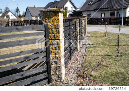 Wooden fence. Landscaped private house street. Exterior and sunny day 89726534