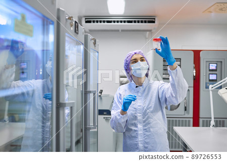 A girl scientist checks a sample for research A girl scientist checks a sample for research 89726553
