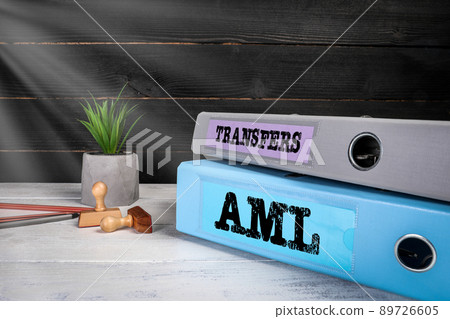 Transfers and AML Anti Money Laundering. Document binders on the office desk Transfers and AML Anti Money Laundering. Document binders on the office desk 89726605
