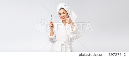 Asian happy woman with toothbrush in bathrobe morning mood 89727342