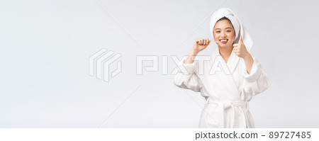 Asian happy woman with toothbrush in bathrobe morning mood 89727485