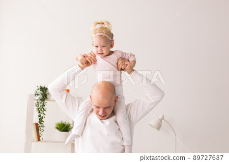 Happy child girl with cochlear implant having fun with her father - hearing aid for deaf and innovative health technology concept 89727687