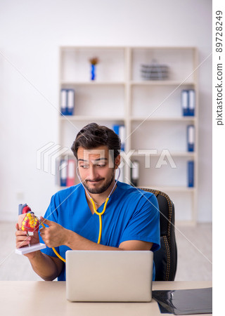 Young male doctor cardiologist working in the clinic 89728249