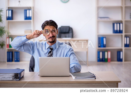 Young male employee working in the office Young male employee working in the office 89728924