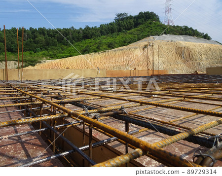 SELANGOR, MALAYSIA -MAY 3, 2022: Steel reinforcement bars for reinforced concrete construction have started to rust after being exposed to weather and water vapor. It can affect rebar if left untreate SELANGOR, MALAYSIA -MAY 3, 2022: Steel reinforcement bars for reinforced concrete construction have started to rust after being exposed to weather and water vapor. It can affect rebar if left untreate 89729314