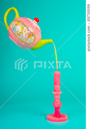 A teapot pours a candle. A teapot pours a candle. 89730099