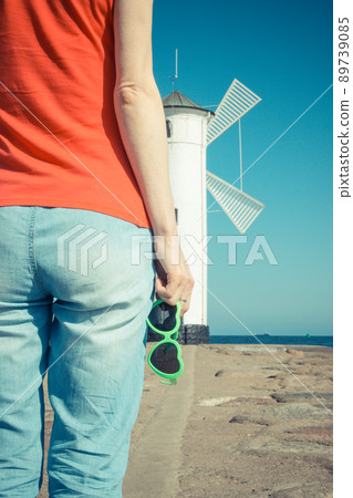 Woman with sunglasses in shape of heart on west breakwater in Swinoujscie Woman with sunglasses in shape of heart on west breakwater in Swinoujscie 89739085
