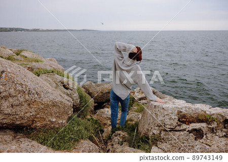 beautiful woman nature rocks coast landscape Ocean female relaxing beautiful woman nature rocks coast landscape Ocean female relaxing 89743149