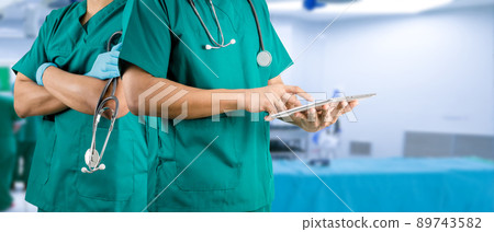 medical concept operating room doctor holding a tablet medical concept operating room doctor holding a tablet 89743582