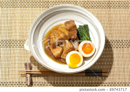 A bird's-eye view of boiled pork in a pot, soft-boiled egg, spinach and chopsticks A bird's-eye view of boiled pork in a pot, soft-boiled egg, spinach and chopsticks 89743717