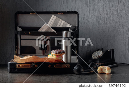 Still life in noir style. Old black phone and unfinished lunch. Still life in noir style. Old black phone and unfinished lunch. 89746192