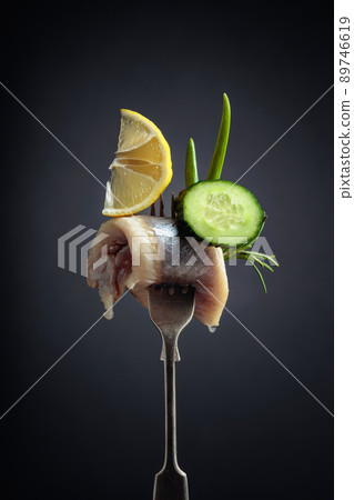 Atlantic herring with lemon, green cucumber, onion and rosemary. Atlantic herring with lemon, green cucumber, onion and rosemary. 89746619