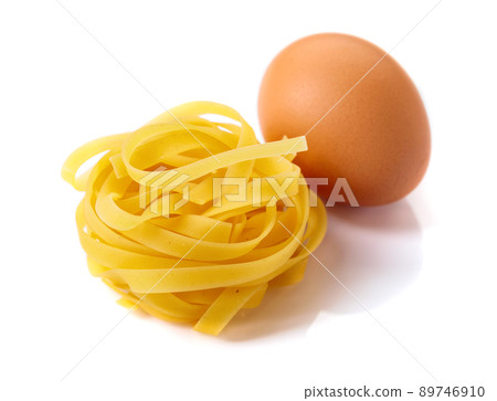 Homemade raw egg noodles on a white background. 89746910