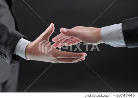 two businessmen are holding out their hands for a handshake. two businessmen are holding out their hands for a handshake. 89747449