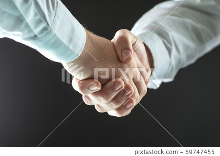 close up. handshake business people. isolated on black background 89747455