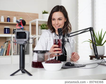 Female nutritionist talking about hibiscus drink infusion tea Female nutritionist talking about hibiscus drink infusion tea 89748366