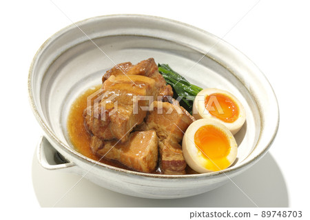鍋中的 Kakuni 豬肉、煮熟的雞蛋和白色背景中的菠菜 89748703
