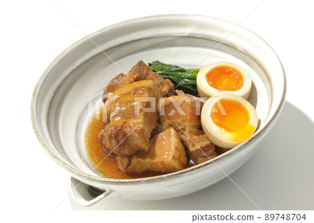 Kakuni pork in a pot, soft-boiled egg and spinach photographed on a white background 89748704