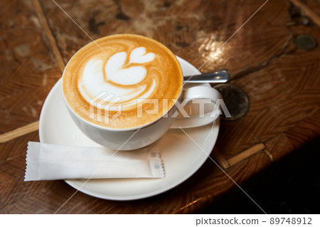 A cup of coffee or Latte with heart pattern in a white cup 89748912