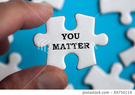 Motivational text on jigsaw puzzle with blue background - You matter. Motivational concept. Motivational text on jigsaw puzzle with blue background - You matter. Motivational concept. 89750119