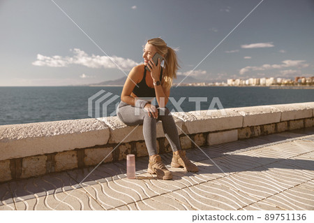 Young attractive female breathing fresh air outdoors 89751136