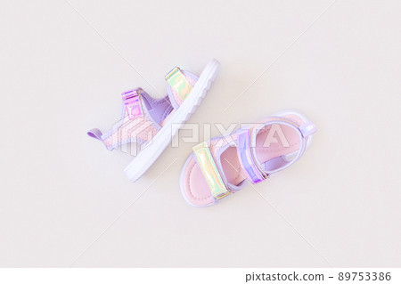 Stylish holographic sandals for kids on grey background. Shiny fashion summer shoes. Flat lay, Top view 89753386