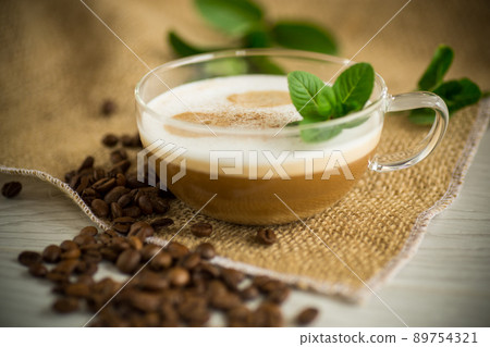 Cup of coffee latte with heart shape and coffee beans Cup of coffee latte with heart shape and coffee beans 89754321