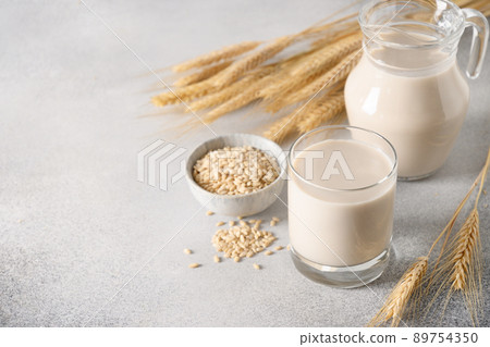 Vegan Barley milk in glass, plant based milk replacer. 89754350