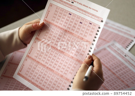 Filling out a lottery ticket. A young woman plays the lottery and dreams of winning the jackpot 89754452