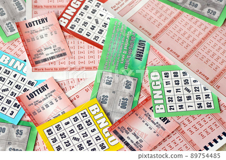 Many used lottery tickets, bills with numbers and bingo playing boards in big pile. Gambling and lottery paper stuff Many used lottery tickets, bills with numbers and bingo playing boards in big pile. Gambling and lottery paper stuff 89754485