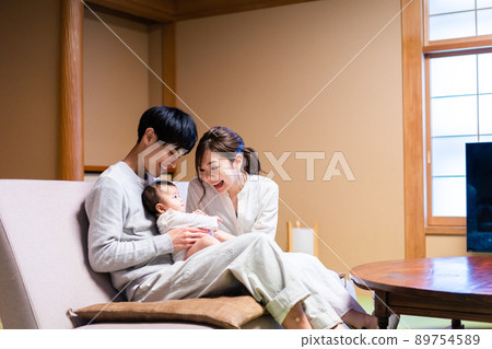 A young family enjoying a hot spring trip with a baby 89754589