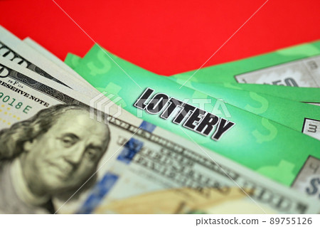 Close up view of green lottery scratch cards and us dollar bills. Many used fake instant lottery tickets with gambling results. Gambling addiction Close up view of green lottery scratch cards and us dollar bills. Many used fake instant lottery tickets with gambling results. Gambling addiction 89755126