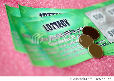Close up view of green lottery scratch cards. Many used fake instant lottery tickets with gambling results. Gambling addiction 89755236