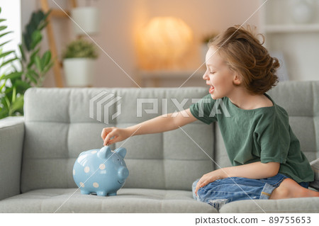 Happy girl with piggy bank Happy girl with piggy bank 89755653