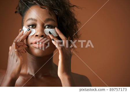Woman Applying Undereye Patches Woman Applying Undereye Patches 89757173