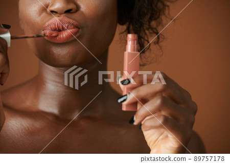 Woman Applying Matte Lipstick 89757178